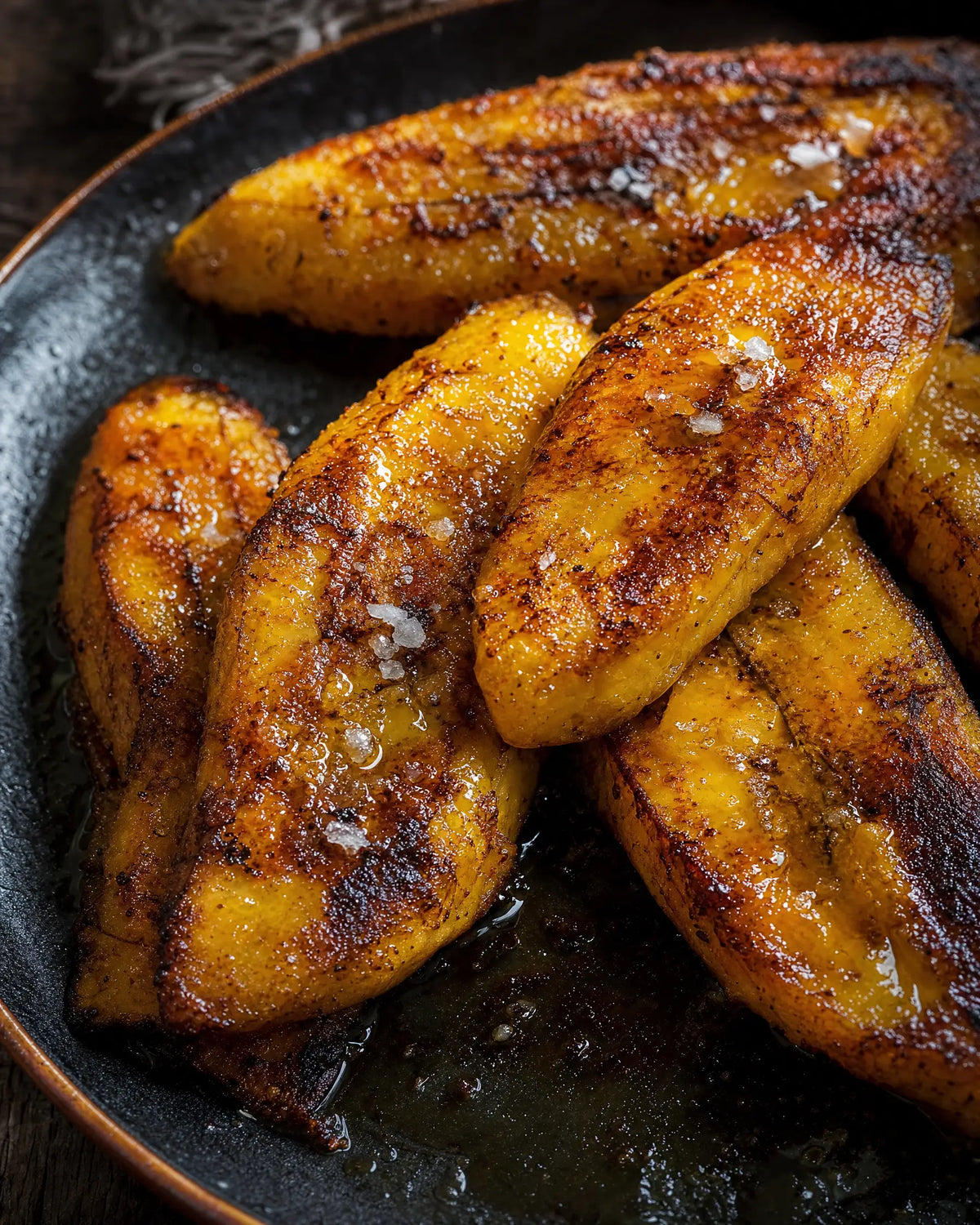 Butter-Fried Plantain Toasts — Thick-sliced plantain fried in butter until the edges caramelize, topped like to...