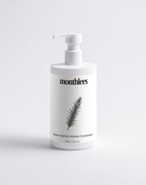 White bottle of 'monthlees' conditioner with a plant design on a light gray background